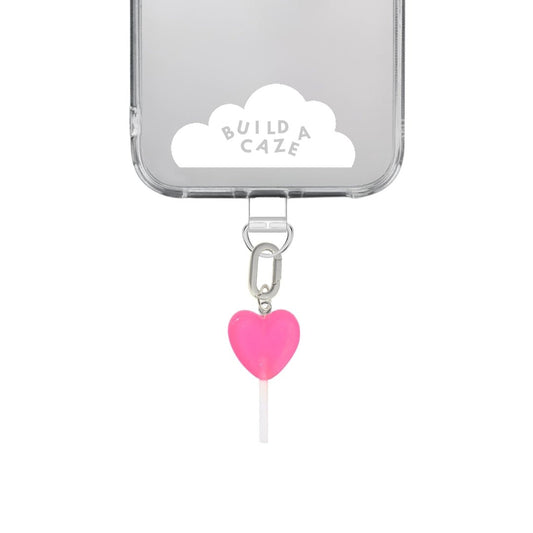 Cute pink heart-shaped lollipop phone charm, sweet Y2K aesthetic mobile accessory and decorative tech strap for phone cases by Build a Caze.