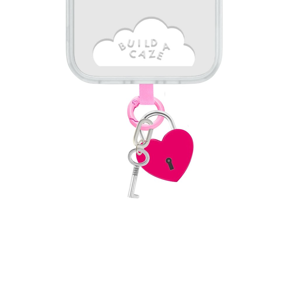 Vibrant pink heart lock phone charm, a bold and bright Y2K aesthetic mobile accessory for phone cases and mirror selfies by Build a Caze.
