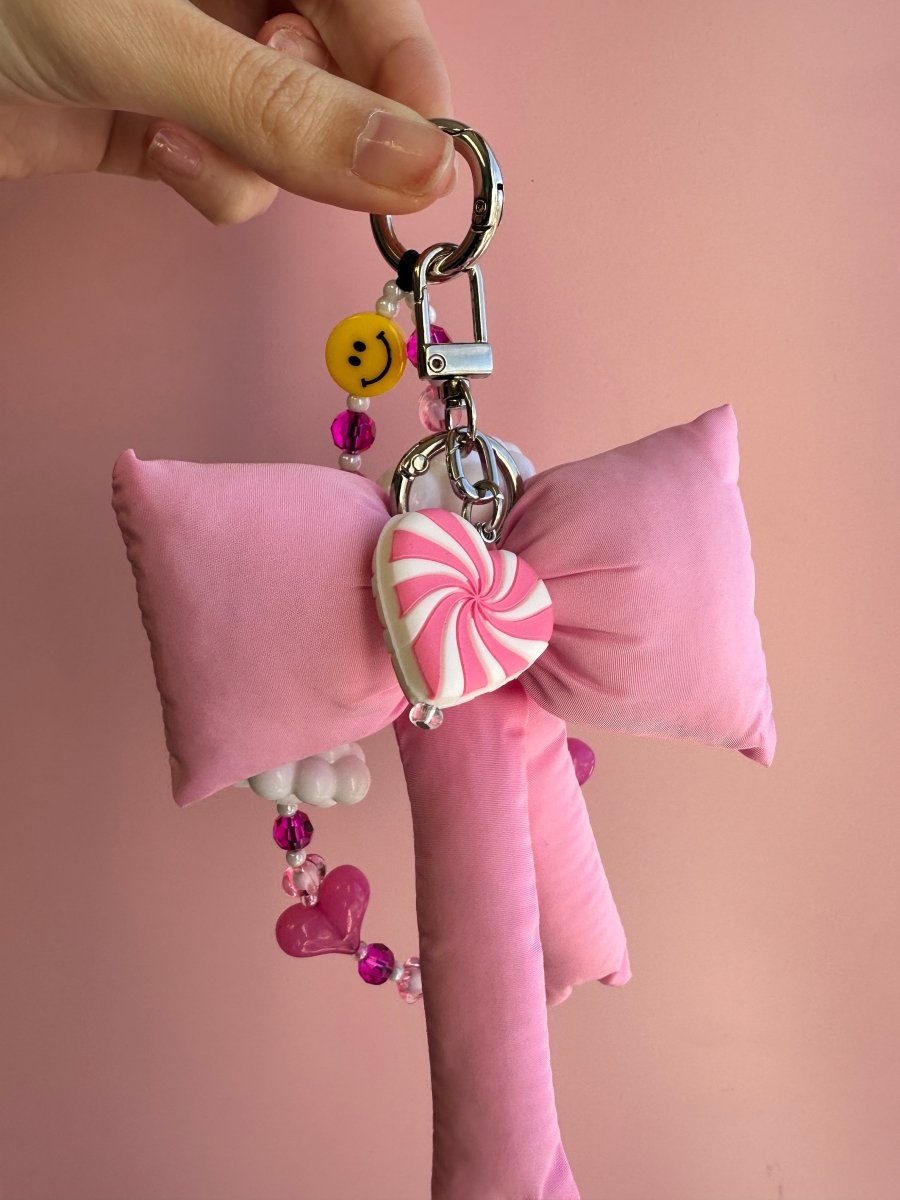 Cute pink sugar swirl phone charm with a marble candy effect, trendy Y2K aesthetic mobile accessory and decorative tech strap by Build a Caze.