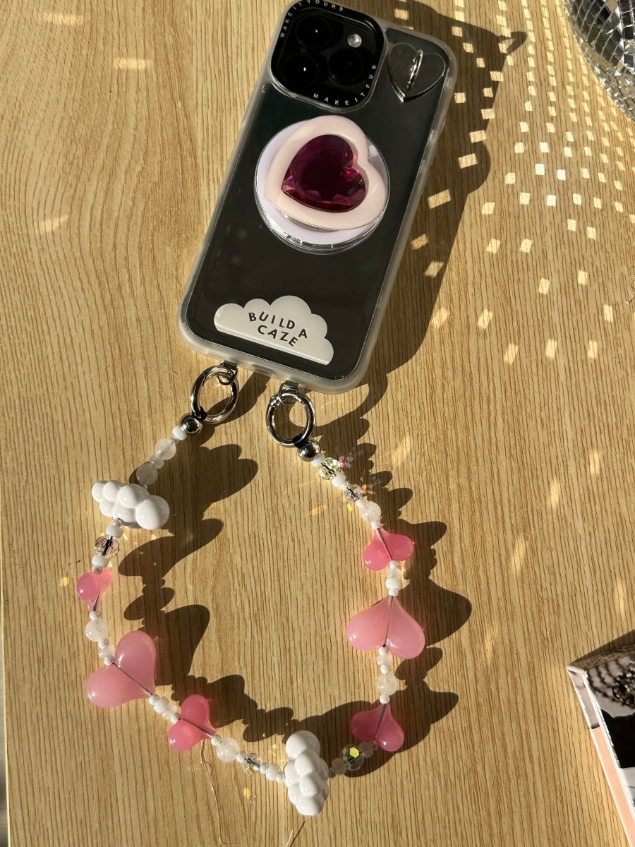 Beaded phone wrist strap featuring vibrant red and pink heart charms, decorative beads, and a black cord lanyard, perfect as a stylish phone strap and mobile phone accessory.