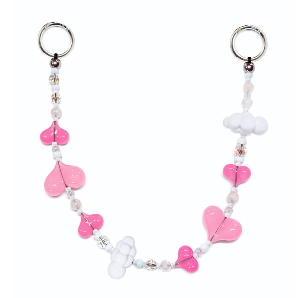 Beaded phone wrist strap featuring soft pink heart beads and white cloud charms with a black cord lanyard, perfect as a decorative phone strap and phone wrist strap accessory for phone cases.