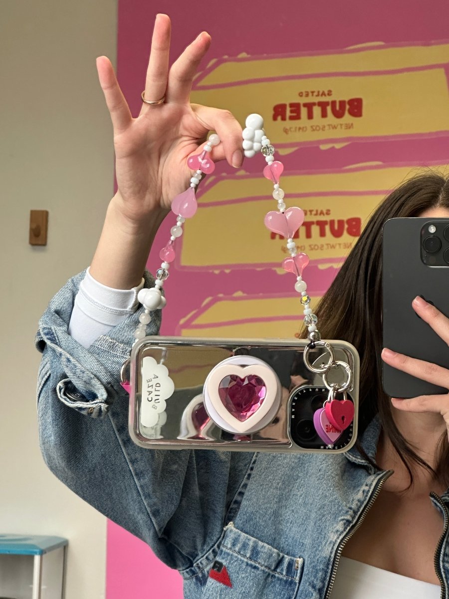 Beaded phone wrist strap featuring vibrant red and pink heart-shaped beads on a black cord lanyard, perfect as a stylish phone strap and mobile phone accessory.
