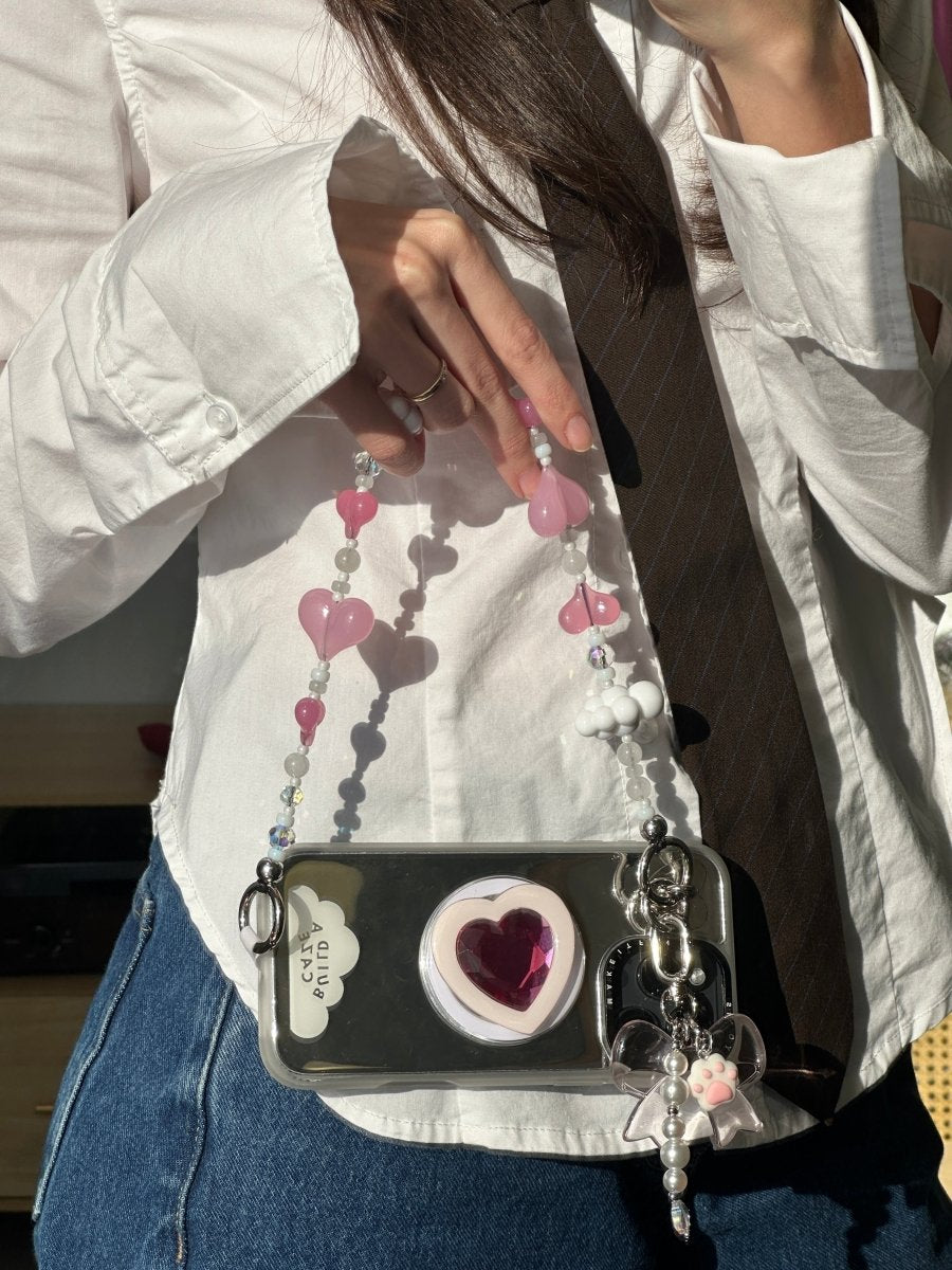 Beaded phone wrist strap featuring vibrant red and pink heart charms and a black cord lanyard, perfect as a decorative phone strap and mobile phone accessory.