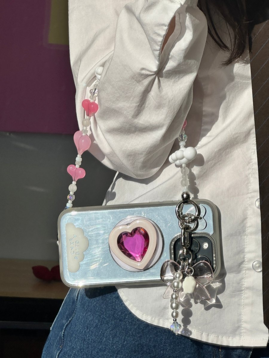Beaded phone wrist strap featuring love-themed beads and heart charms on a black cord lanyard, perfect as a decorative phone strap and stylish phone wrist strap accessory.
