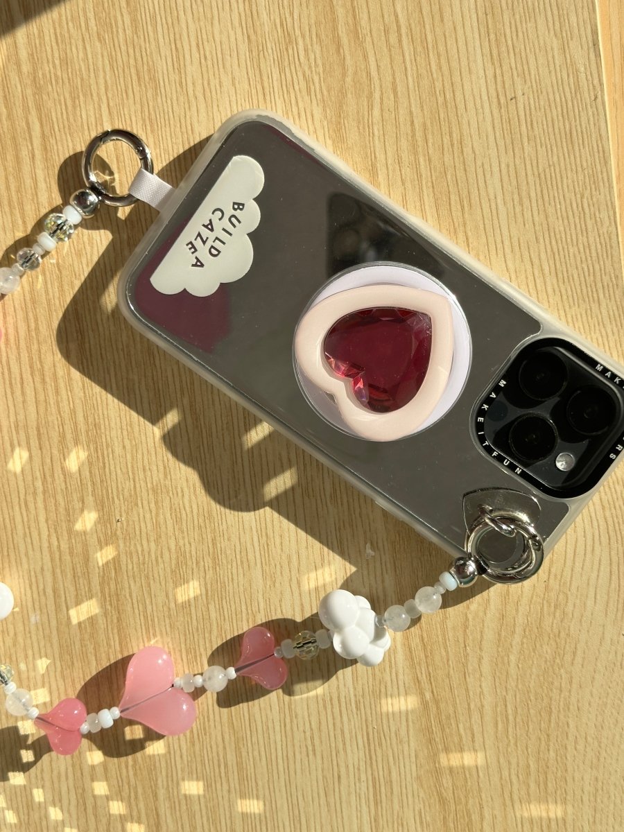 Beaded phone wrist strap featuring vibrant red and pink heart charms and a black cord lanyard, perfect as a decorative phone strap and mobile phone accessory.