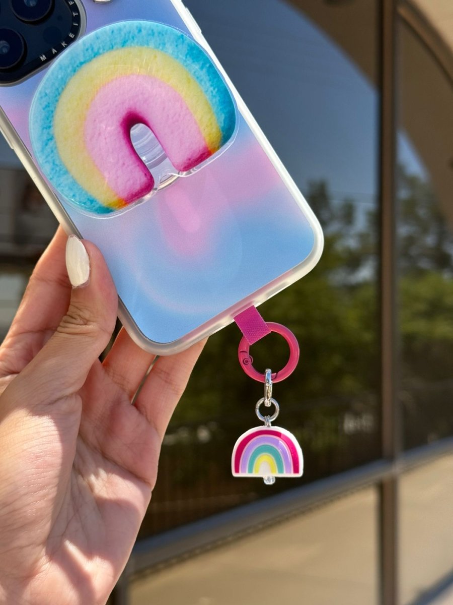 Multicolor pastel Rainbow Dreamie Charmie charm and dangly accessory shown attached to a phone - Build A Caze