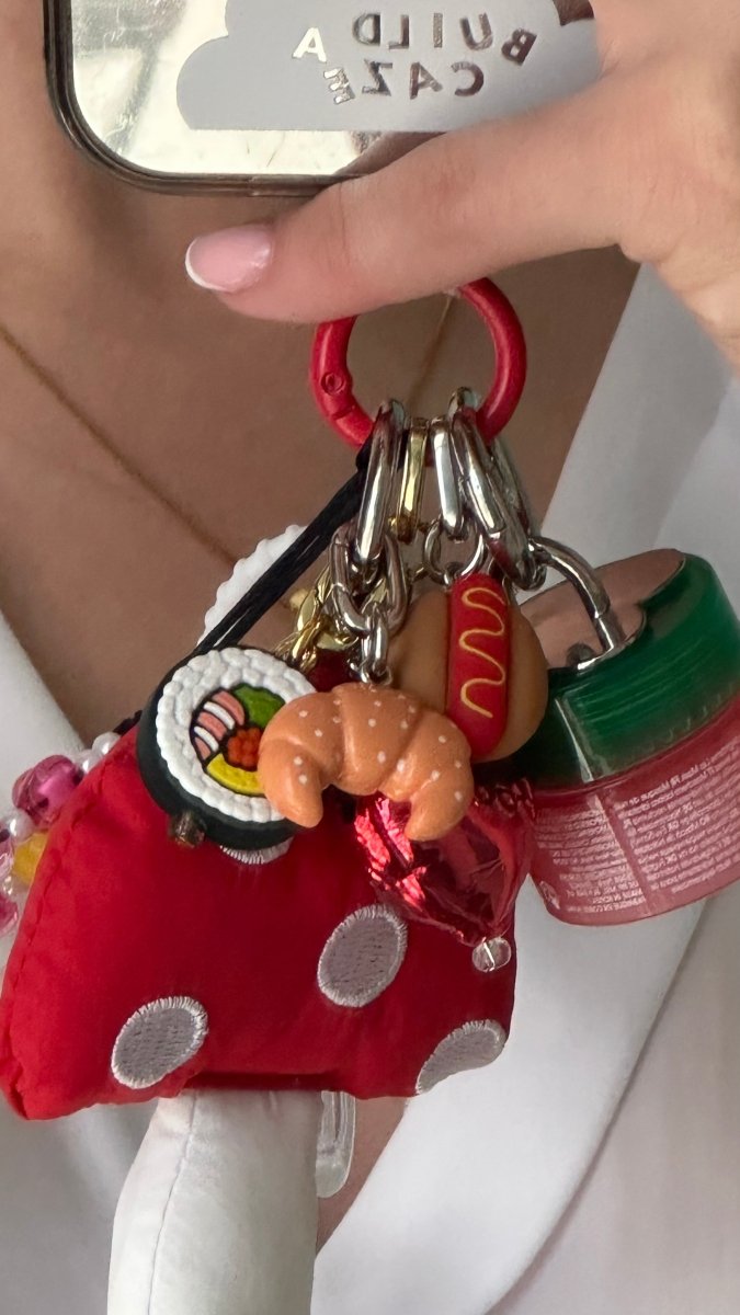 Red puffy mushroom keychain, cute cottagecore fungi charm for phone cases and bags, soft plush aesthetic mobile accessory, whimsical woodland themed keychain attachment.