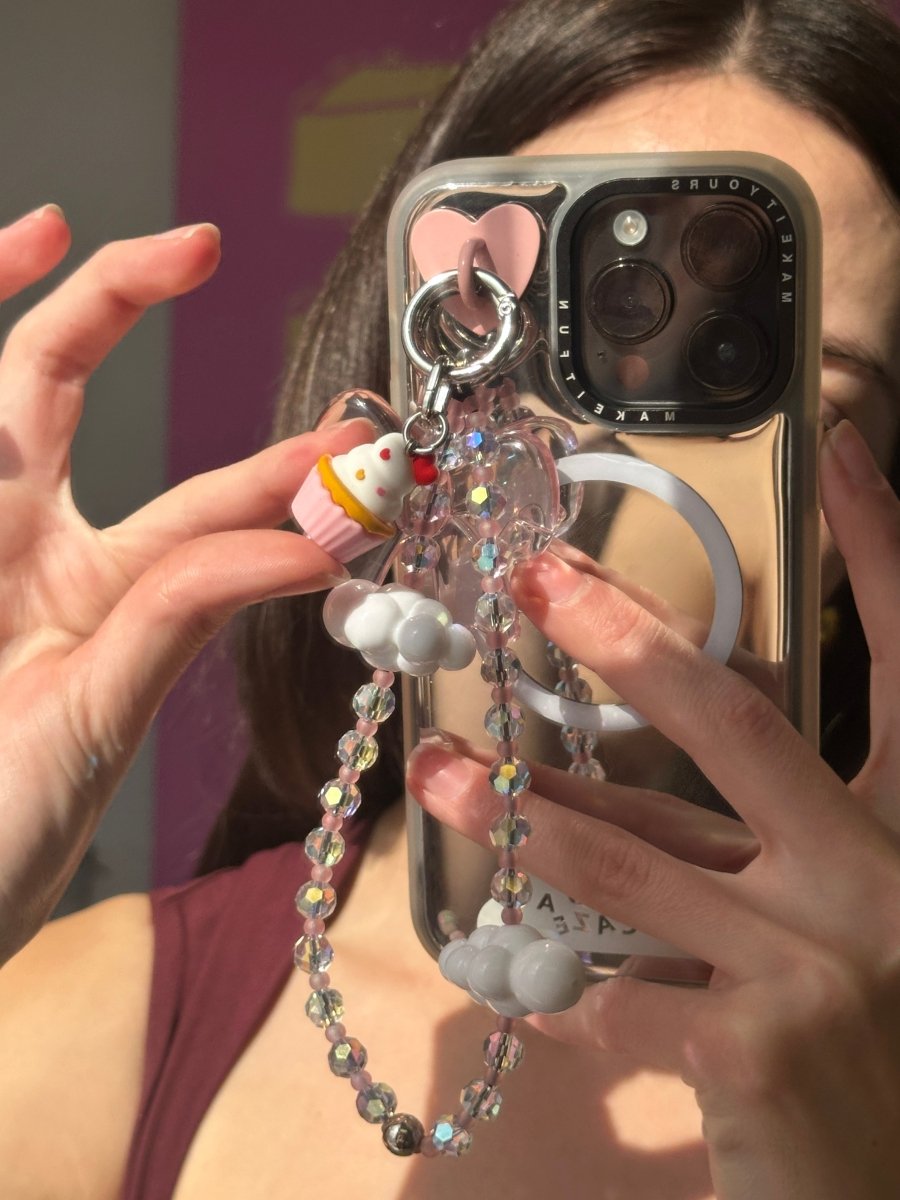 Adorable strawberry dessert phone charm with whipped cream and a cherry on top, cute Y2K aesthetic mobile accessory and decorative tech strap for phone cases by Build a Caze.