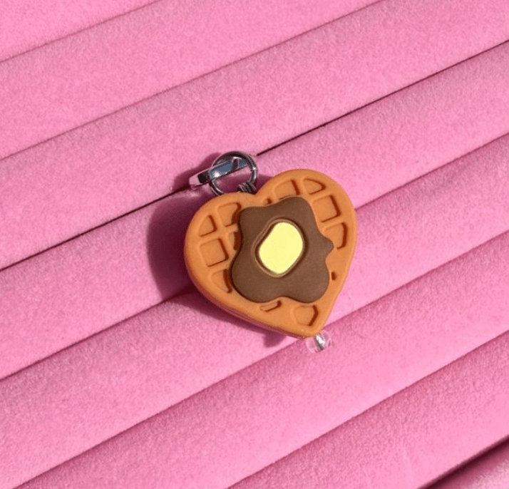 Heart-shaped waffle phone charm topped with a fried egg design, Build A Caze.